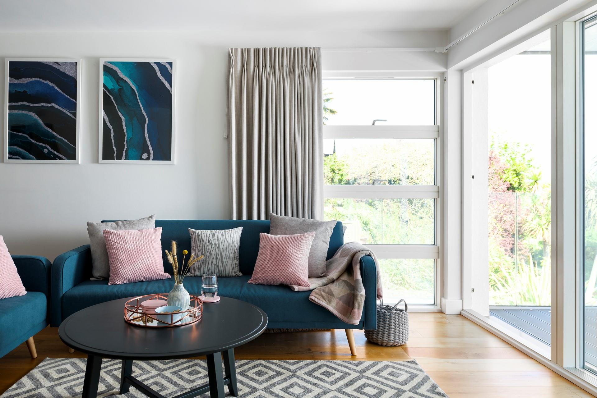 Plump pastel cushions invite you to sink down and relax; admire the unforgettable view through the floor-to-ceiling windows. 