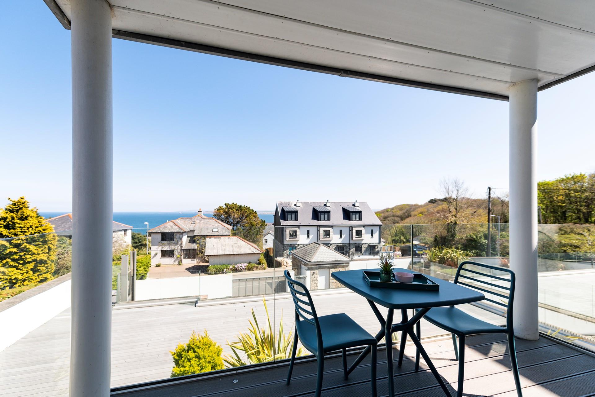 Nestled between two pillars is a private decked balcony with generous sea views. 