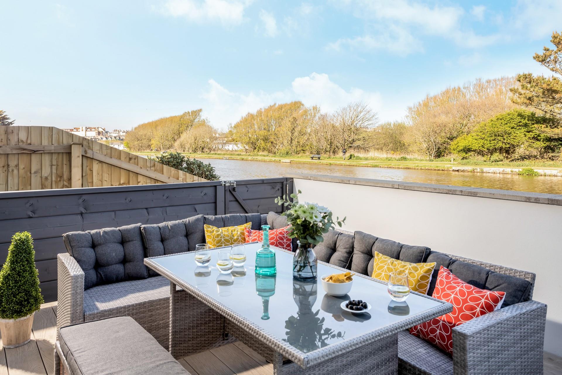 Relax on the rattan furniture overlooking the peaceful canal.