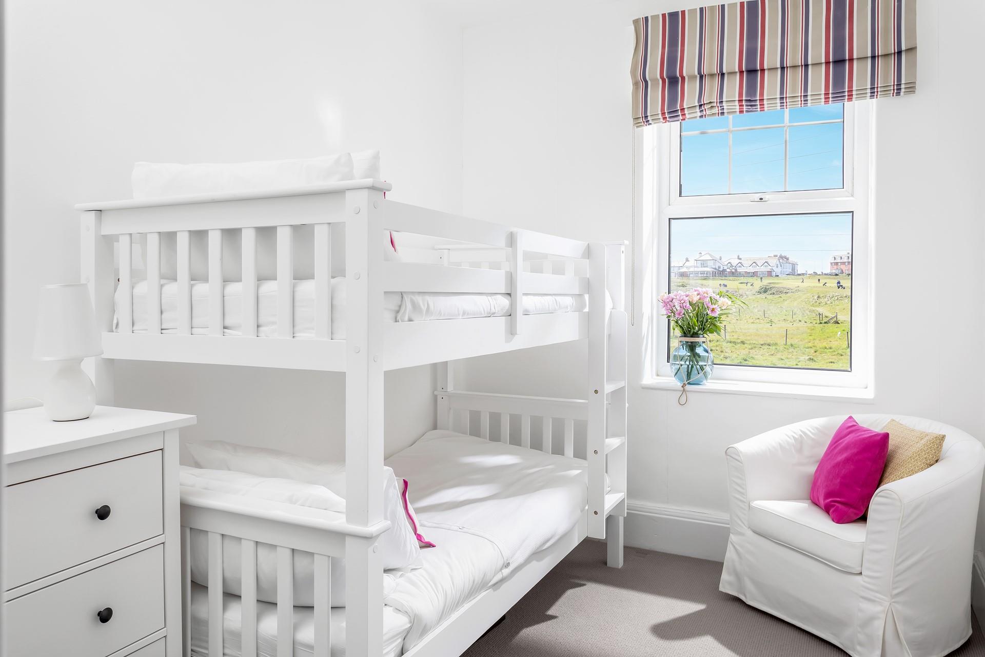 Bedroom 5 has wooden bunk beds perfect for the little ones.