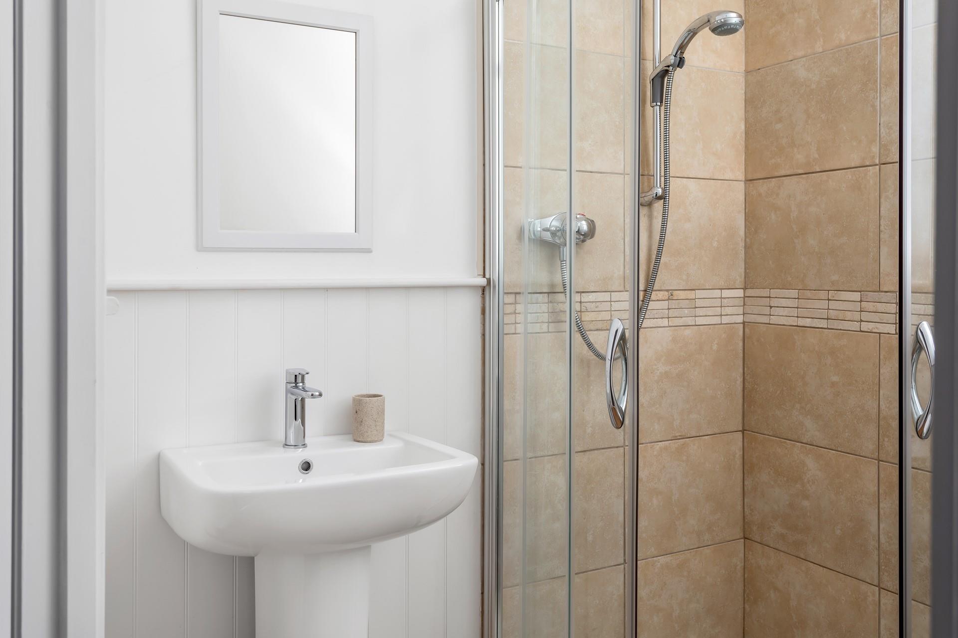 The en suite shower room is perfect for washing off sandy toes after beach days.
