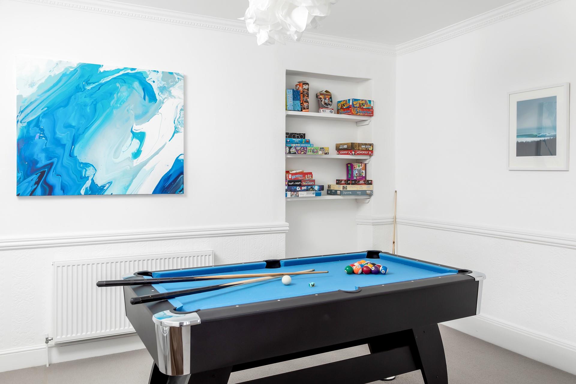 The games room area has a pool table and is fully loaded with family board games to keep friends and family entertained. 
