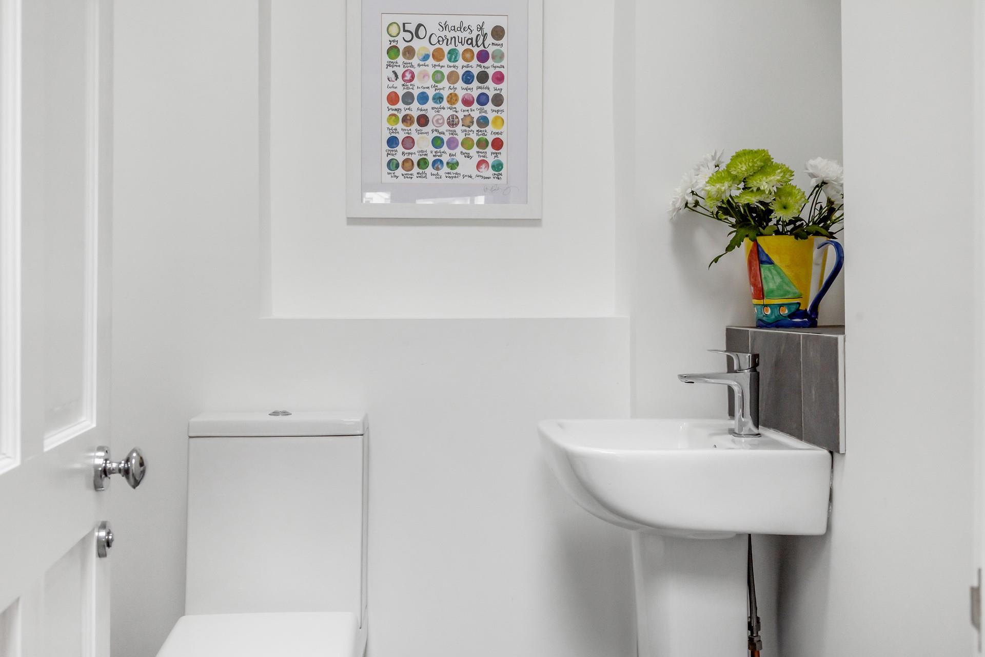 The downstairs cloakroom is accessed from the utility area.