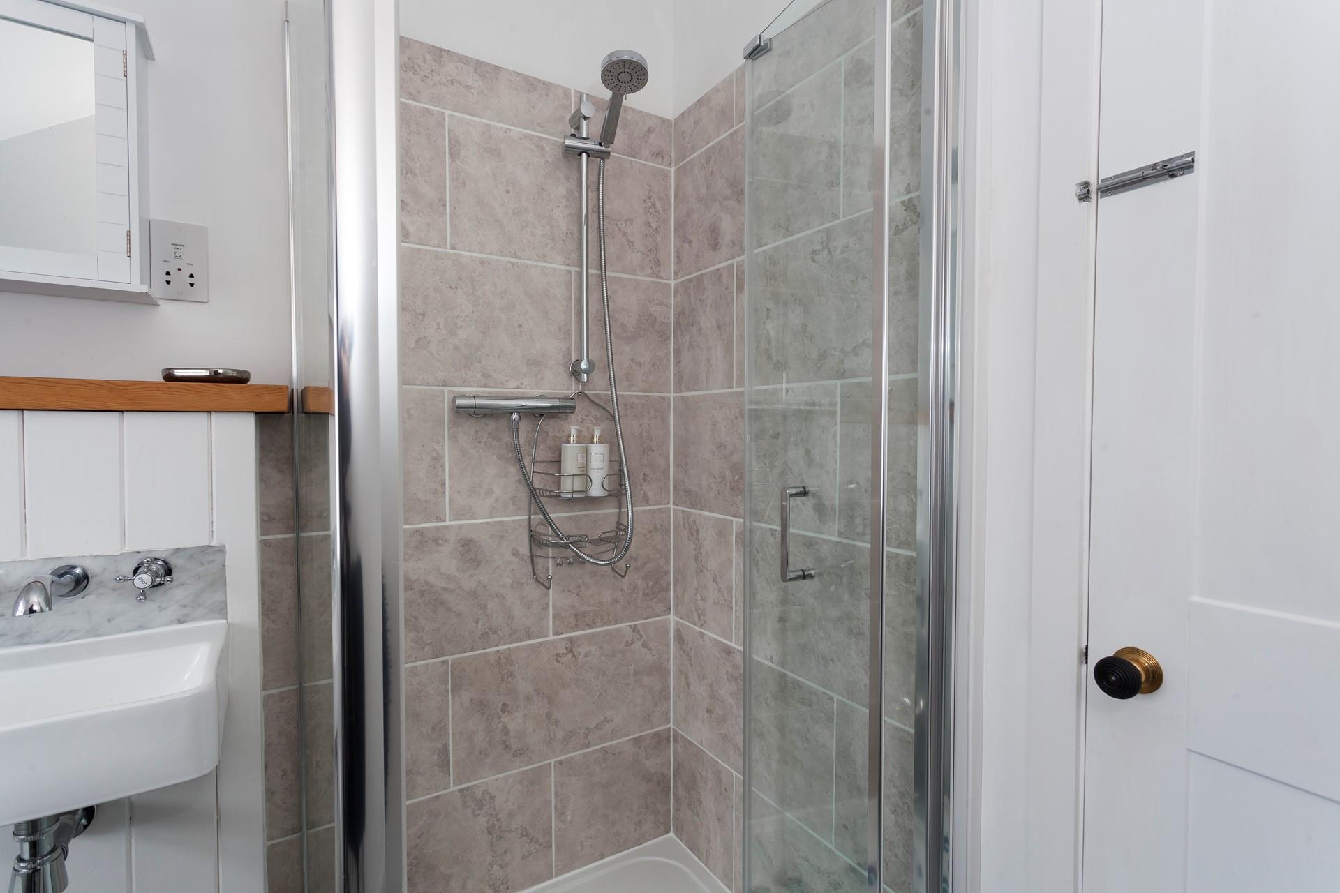 Wash off the sand in the shower and then light the woodburner for a cosy evening in.