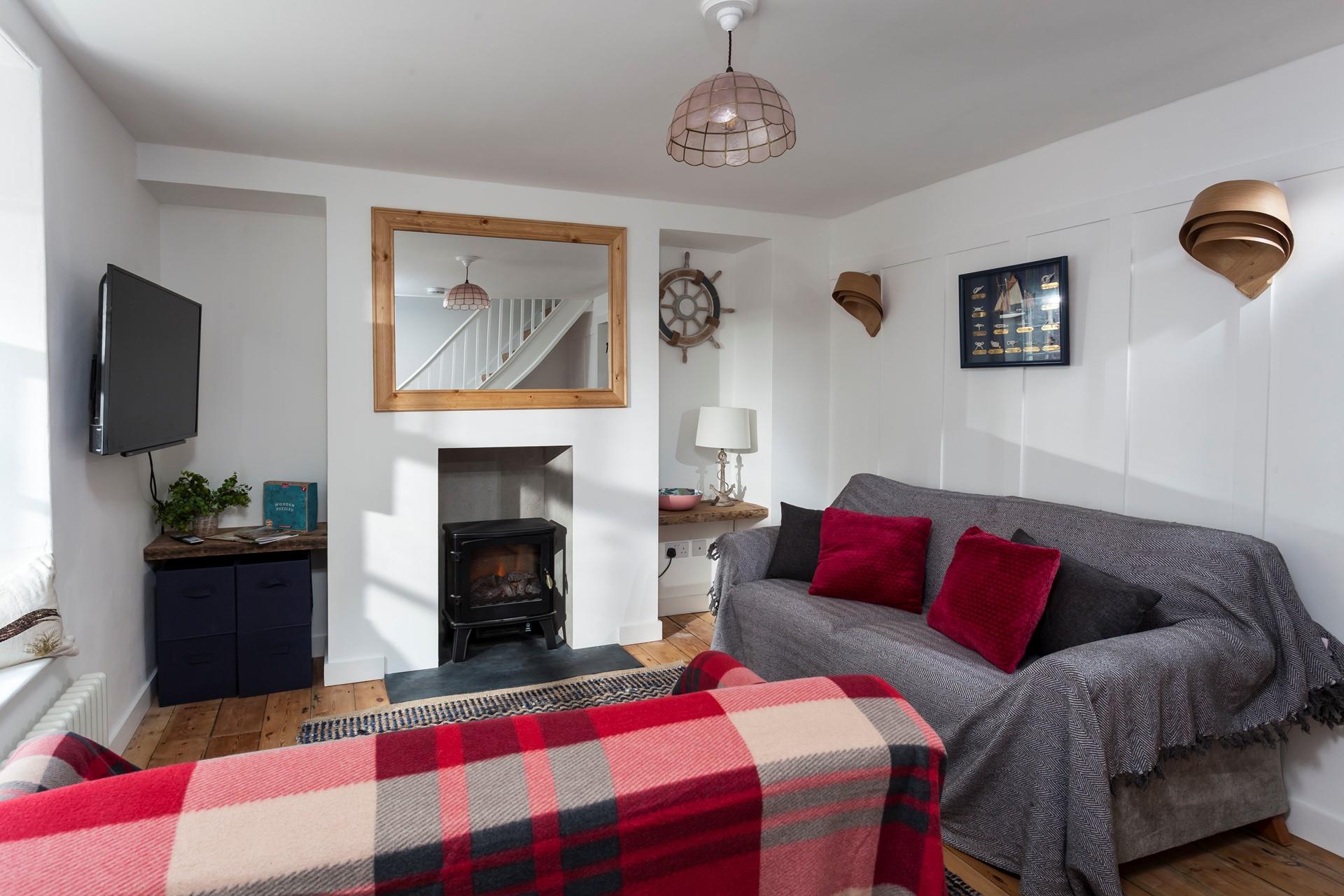 The cosy sitting room features a woodburner, perfect for those chilly evenings.