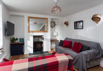 The cosy sitting room features a woodburner, perfect for those chilly evenings.
