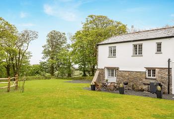 Enjoy an afternoon barbecue surrounded by leafy trees soaking up the sun.