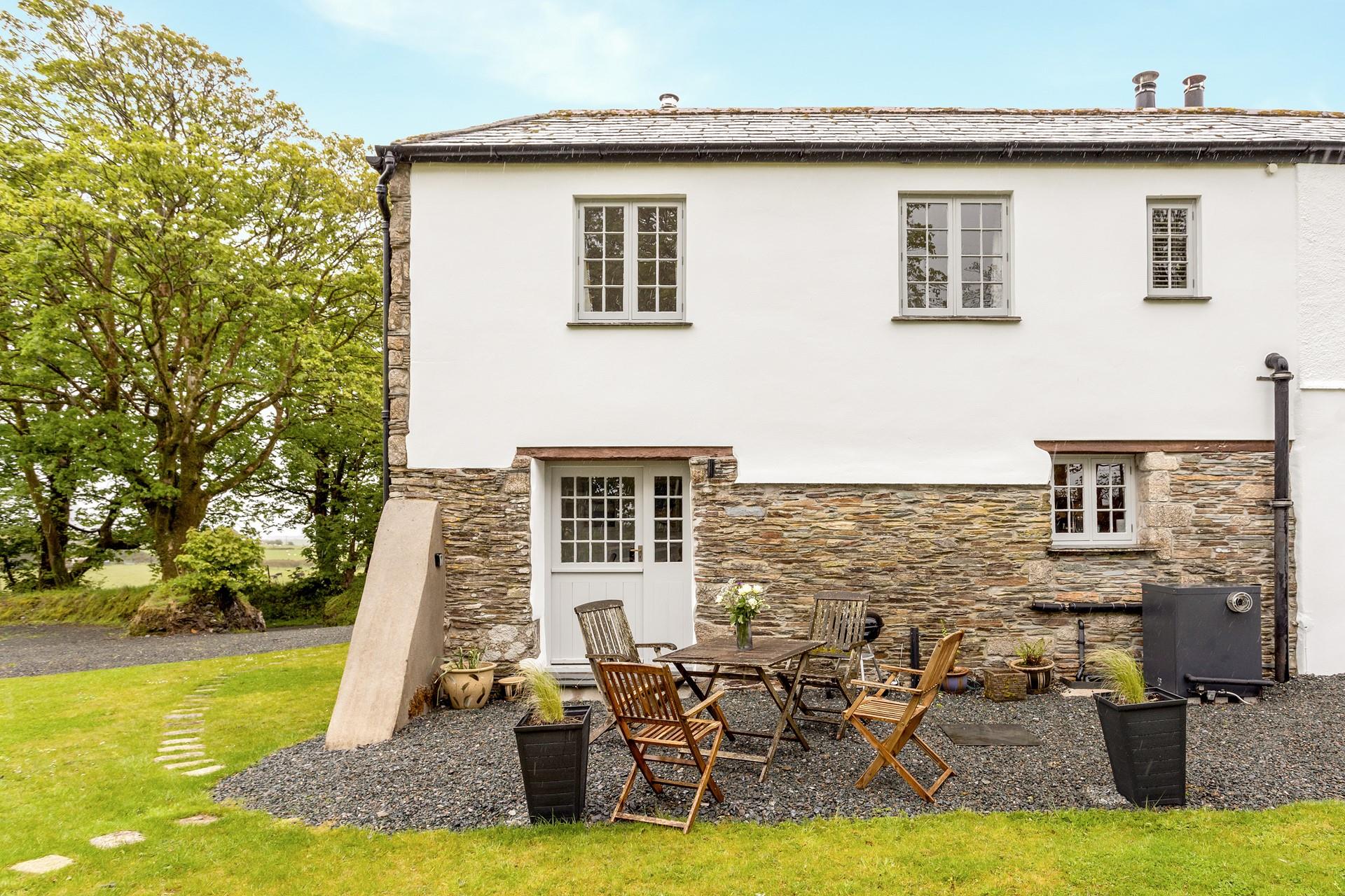 Unwind in the garden, surrounded by leafy trees and rolling fields.