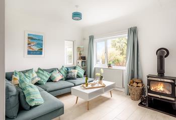 Snuggle up in front of the woodburner in the cosy sitting room after a day on Widemouth Bay beach.