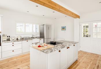 The kitchen is fully equipped and modern, perfect for cooking up a storm.