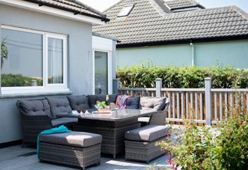 The comfortable rattan furniture is the perfect spot for alfresco dining in the summer.