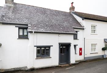 The quaint Post Box Cottage is named after its own red post box. 