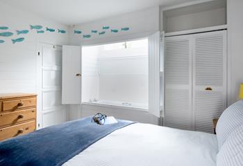 This bedroom has a surprising feature - a bath hidden behind cupboard doors!