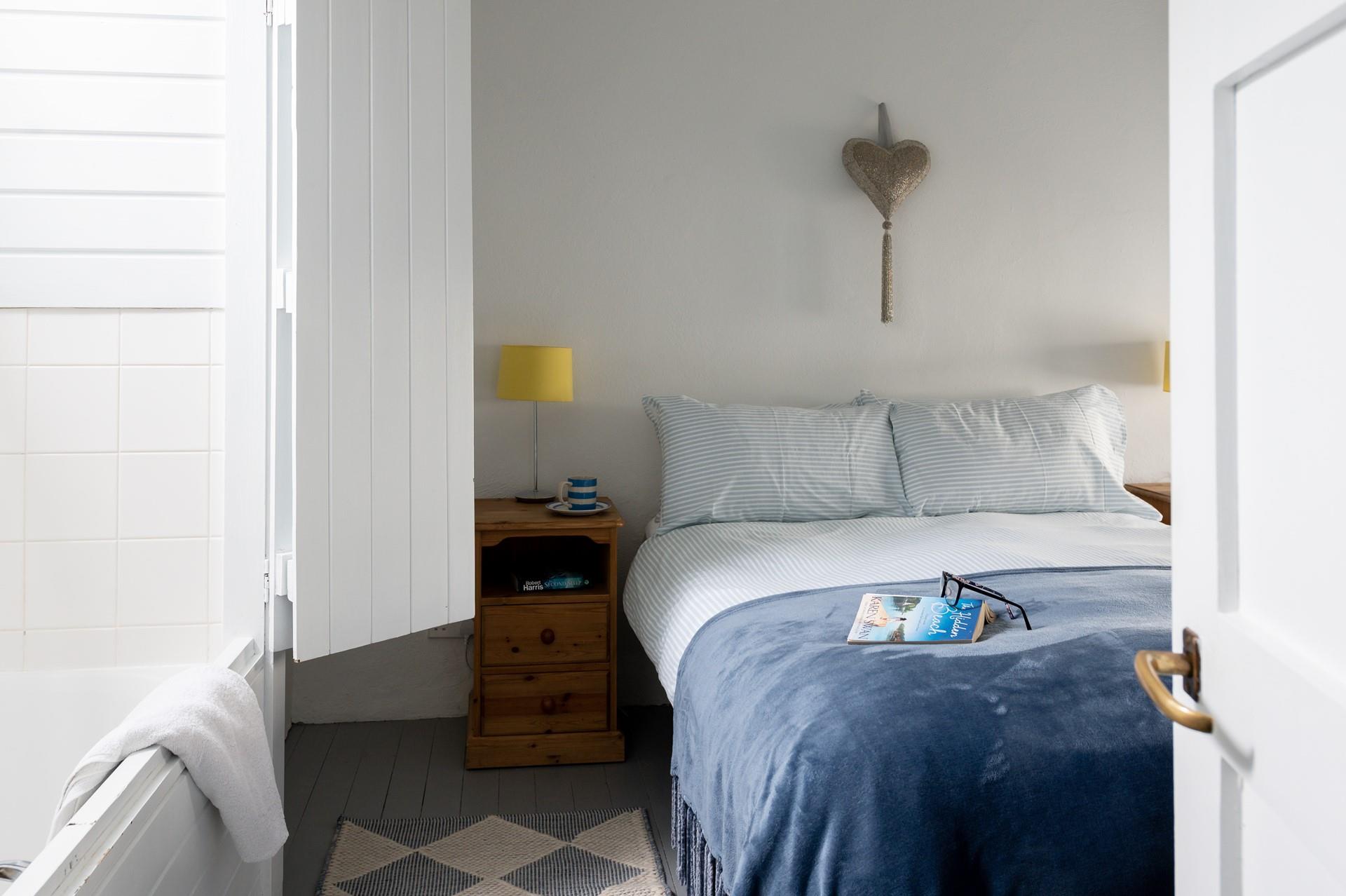 Blues and whites create a calming atmosphere in the main bedroom.