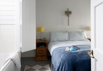 Blues and whites create a calming atmosphere in the main bedroom.