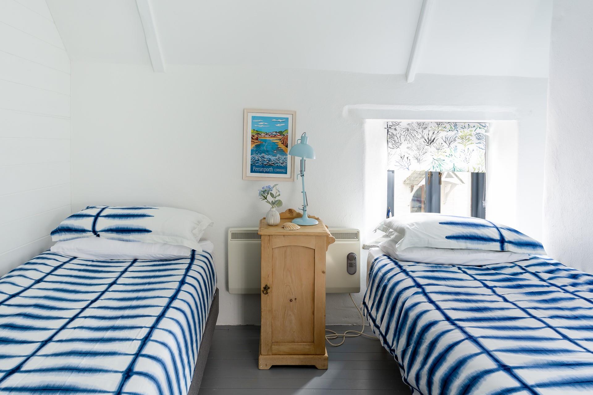 We love the calming coastal elements of the room, including the artwork and blind. 
