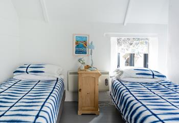 We love the calming coastal elements of the room, including the artwork and blind. 