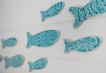 We love the blue ceramic fish decorations adorning the wall. 