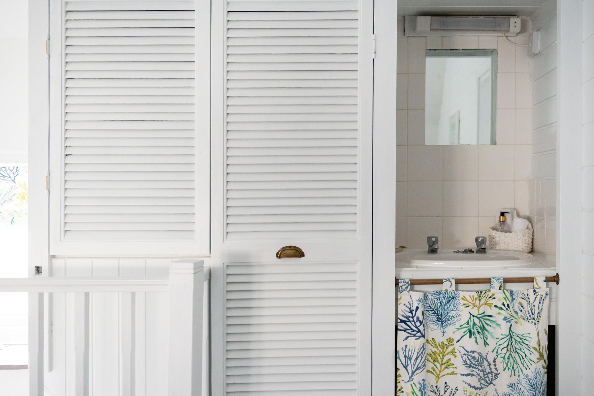The shower room features this cute little sink!