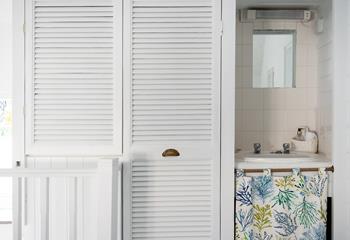 The shower room features this cute little sink!