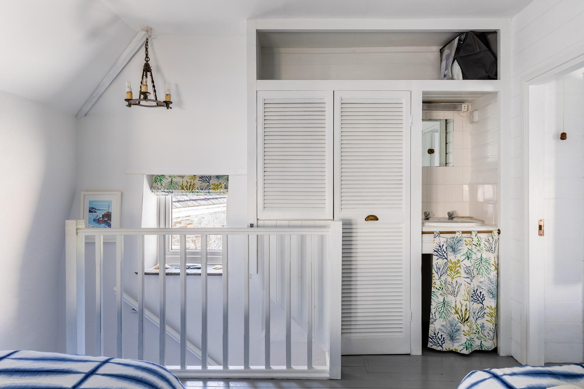 The twin bedroom features a quaint sink!