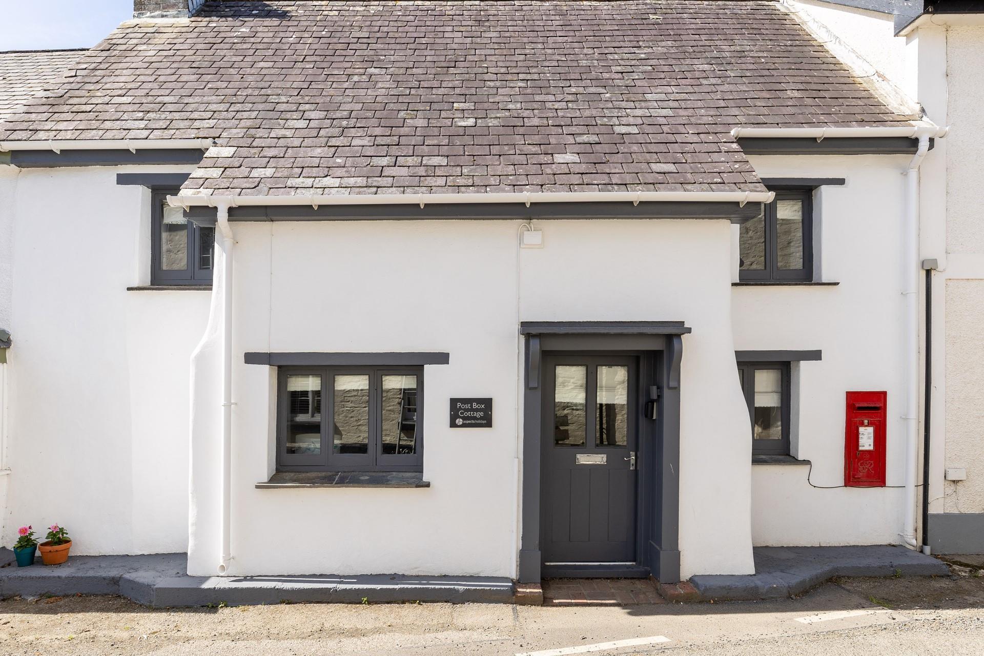 The quaint Post Box Cottage is named after its own red post box. 