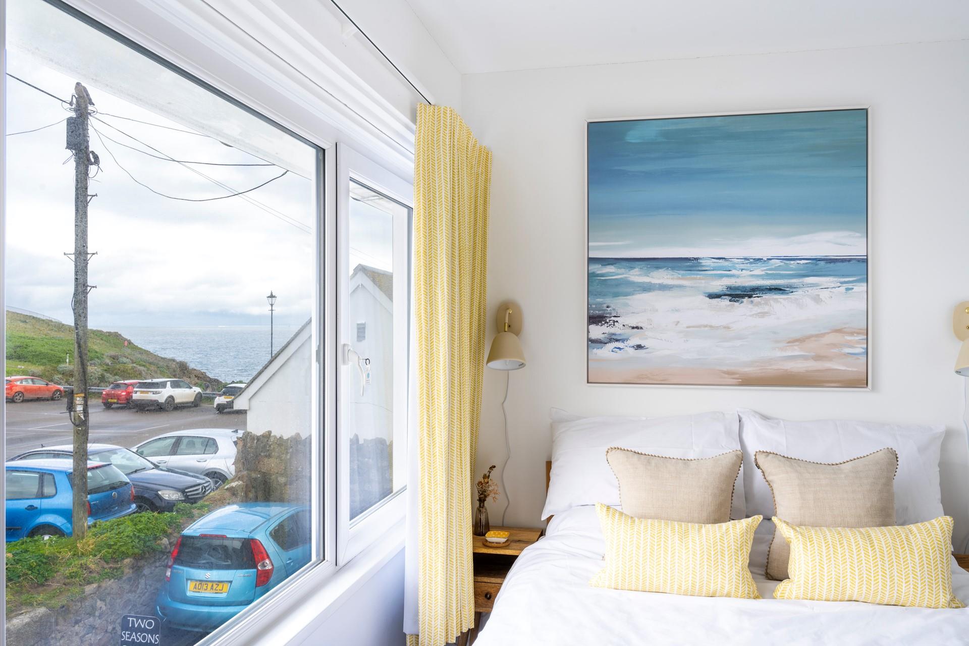 We love the contemporary seaside artwork above the bed!