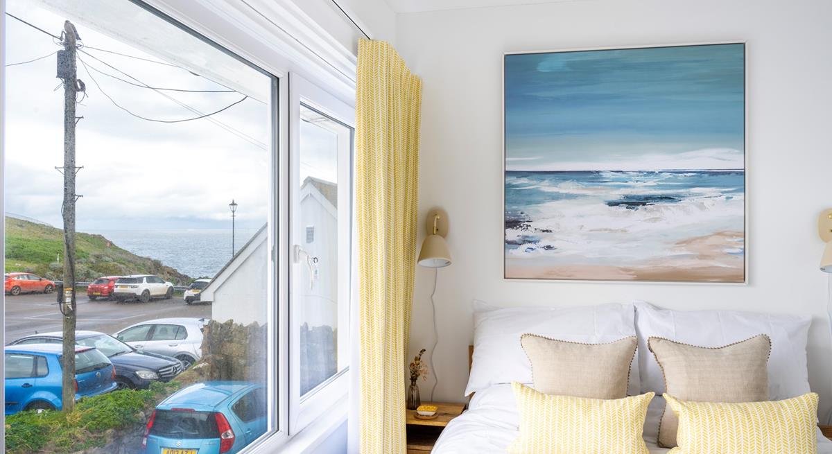 We love the contemporary seaside artwork above the bed!