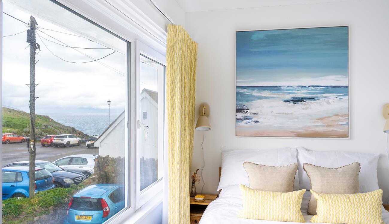 We love the contemporary seaside artwork above the bed!