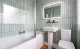 We love the shell-like tiles in the family bathroom.  - Thumbnail Image