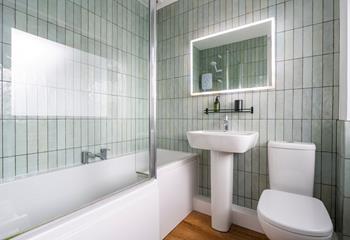 We love the shell-like tiles in the family bathroom. 