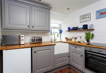Fully equipped, the kitchen has all you need for your time at Tom's Harbour Light; we especially love the Belfast sink. 