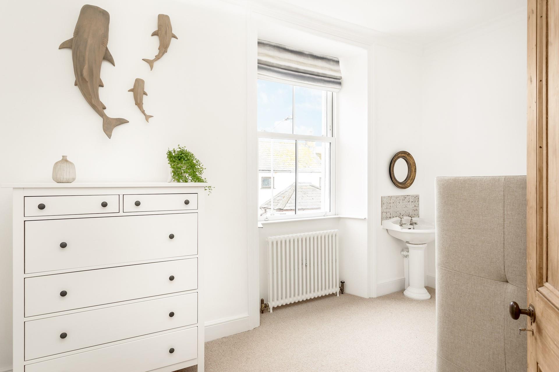 Bedroom 2 is on the first floor, with full size bunk beds and a basin.