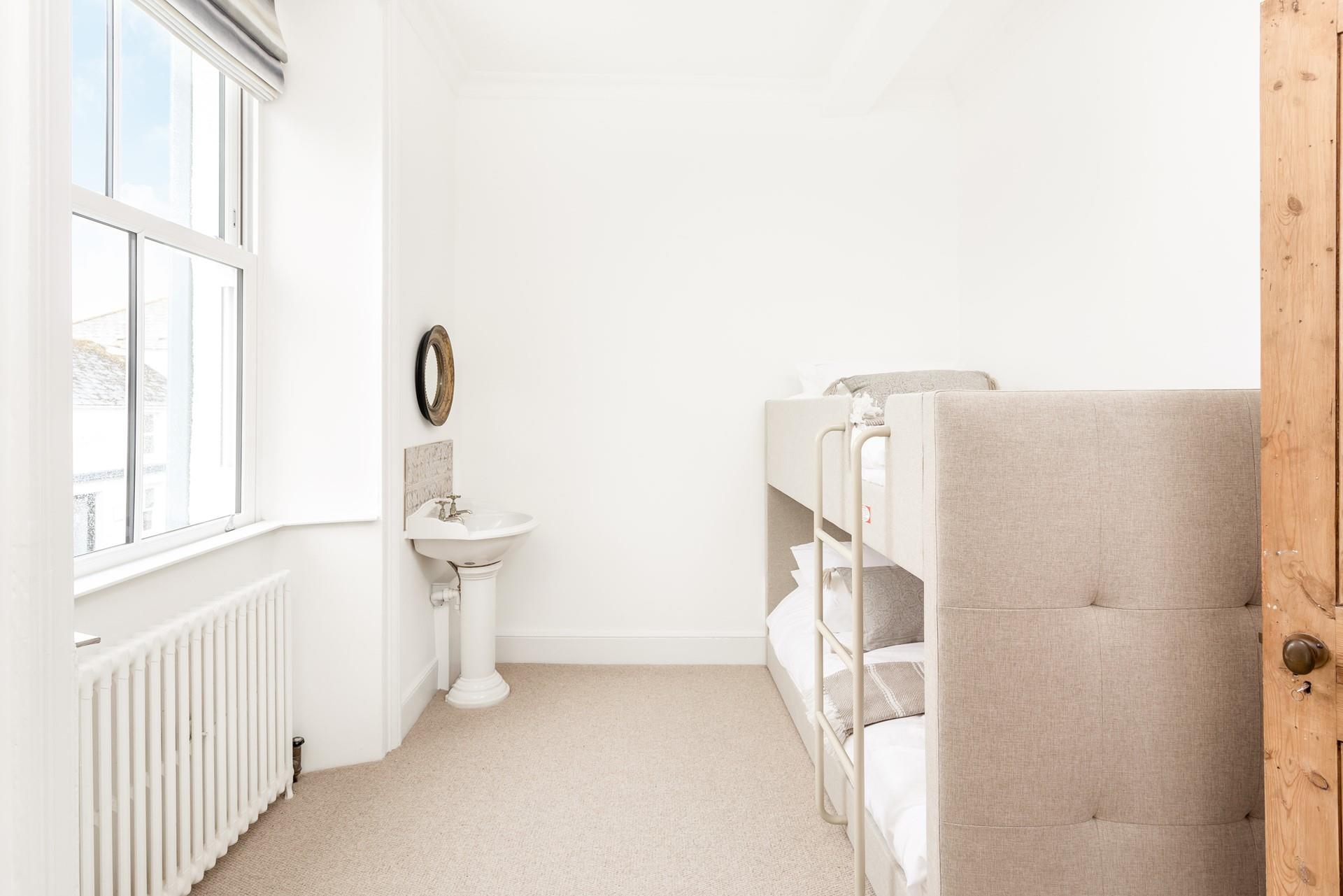 The bunk beds in bedroom 2 are full size singles, so suitable for both children and smaller adults.