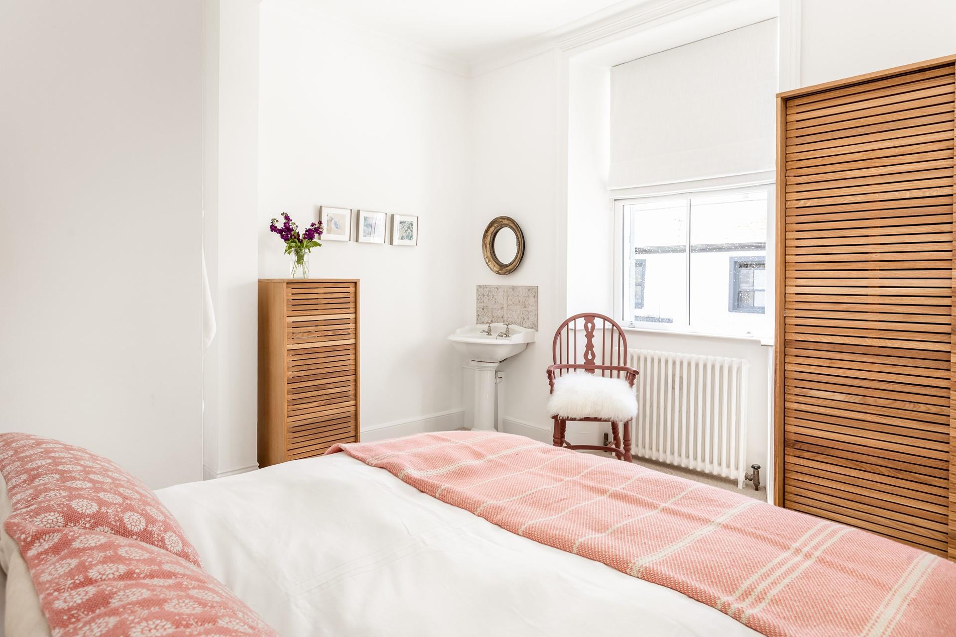 Bedroom 4 is at the front side of the house, with a comfortable king size bed and plenty of storage. 