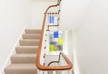 Sweeping staircases and beautiful stained glass windows, add to the wow factor of this beautiful house.