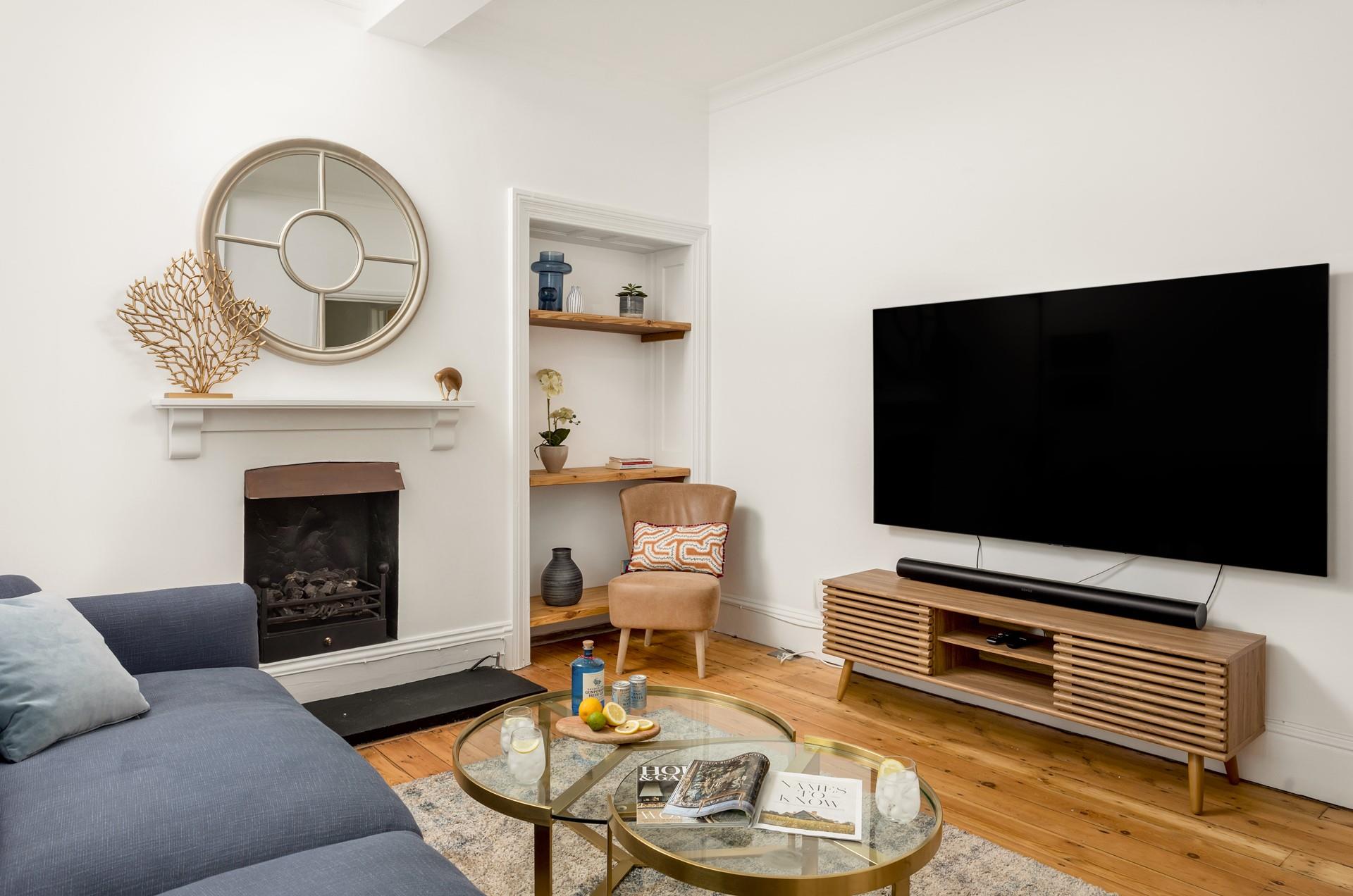 The smart TV with sound bar makes the ground floor living room a hit with the kids, who can enjoy their favourite films together. 