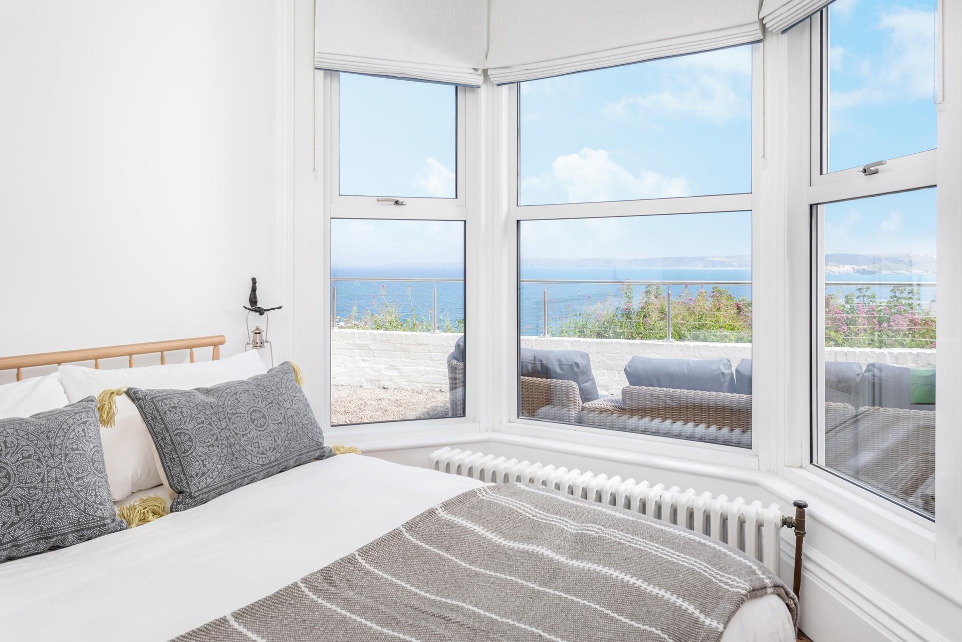 Bedroom 1 on the ground floor enjoys more lovely views, looking out to the terrace and views beyond. 
