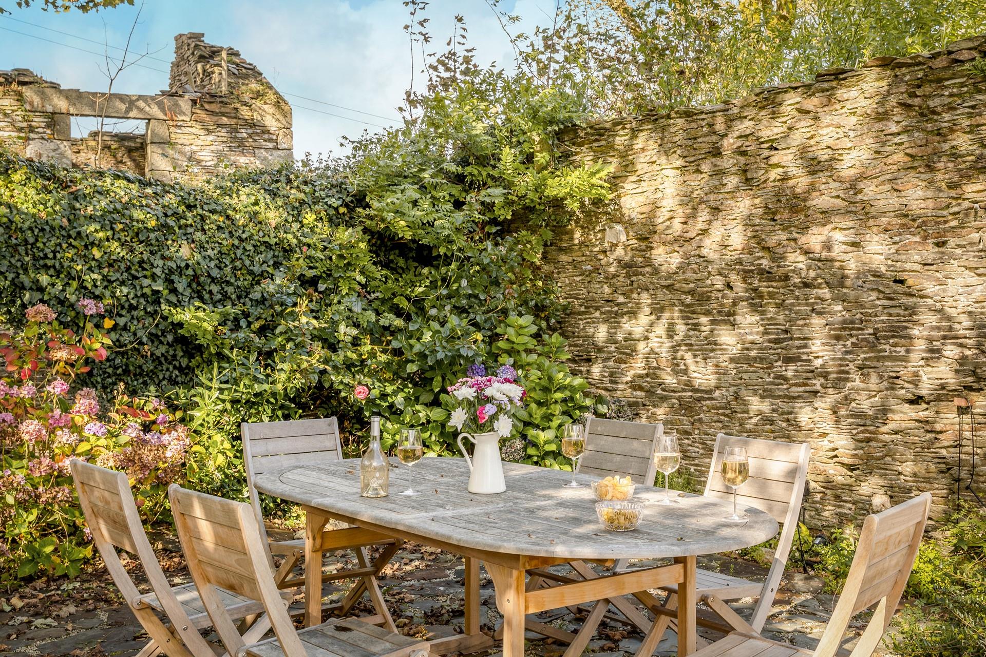 Soak up the sunshine in the blooming garden with a glass of wine.