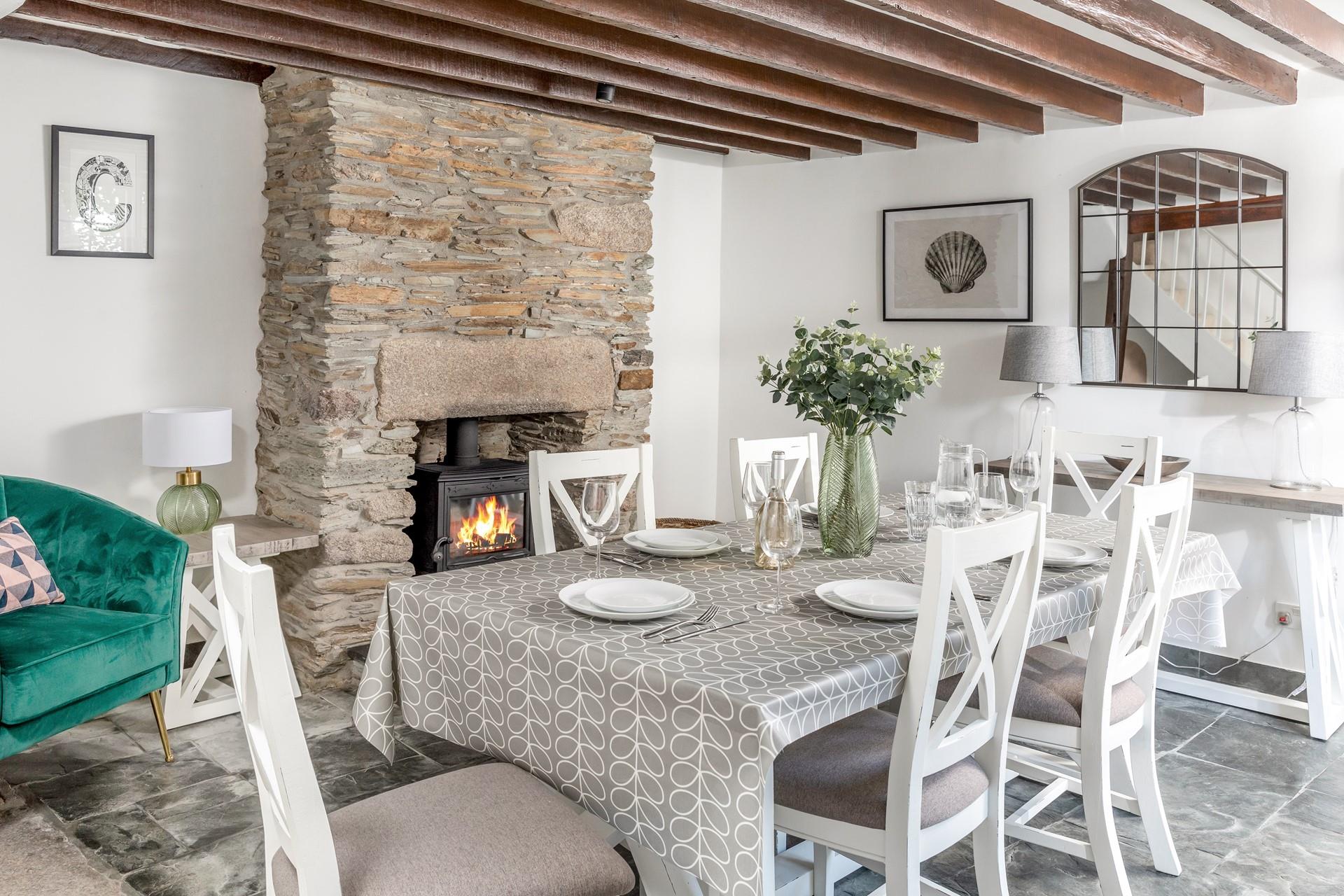 Gather around the table for a hearty Sunday lunch, with the flickering woodburner in the background.