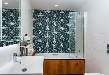 Unique tiles create a striking feature in the bathroom. 