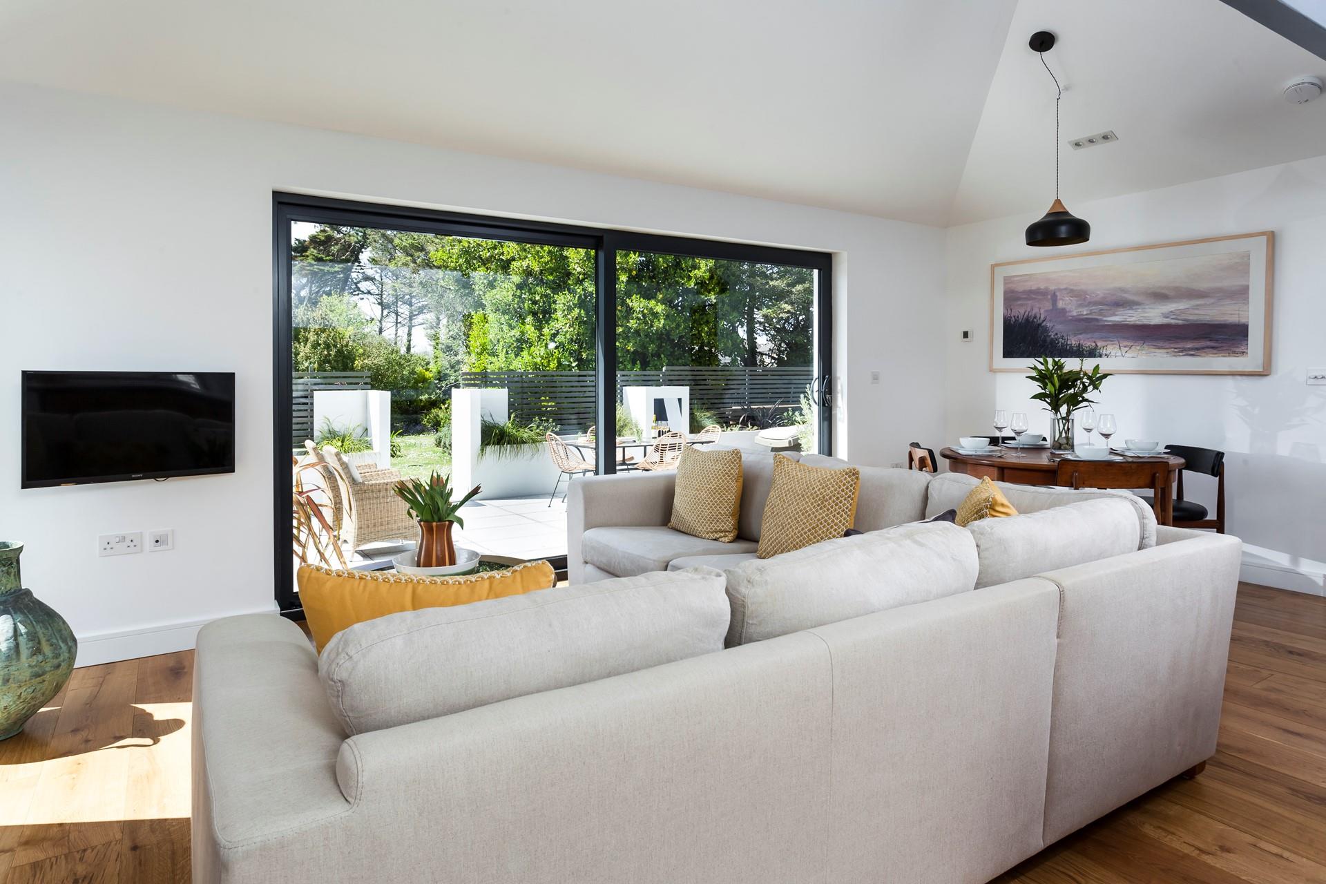 Relax together on the large sumptuous sofa, taking in the garden views. 