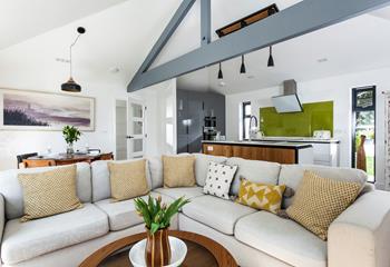 The living area has a real wow factor with its vaulted ceiling and stylish furniture. 