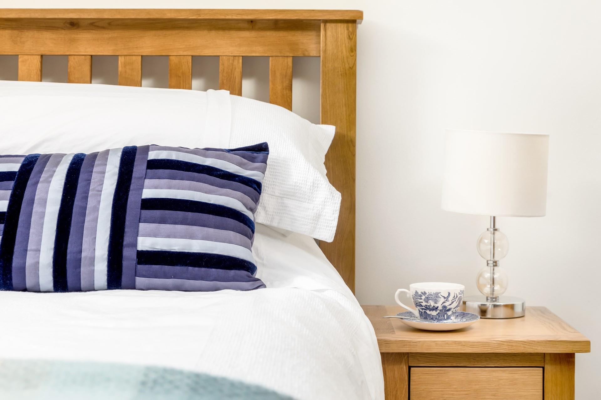 Crisp white linen and shades of blue reflect the close proximity to the sea.