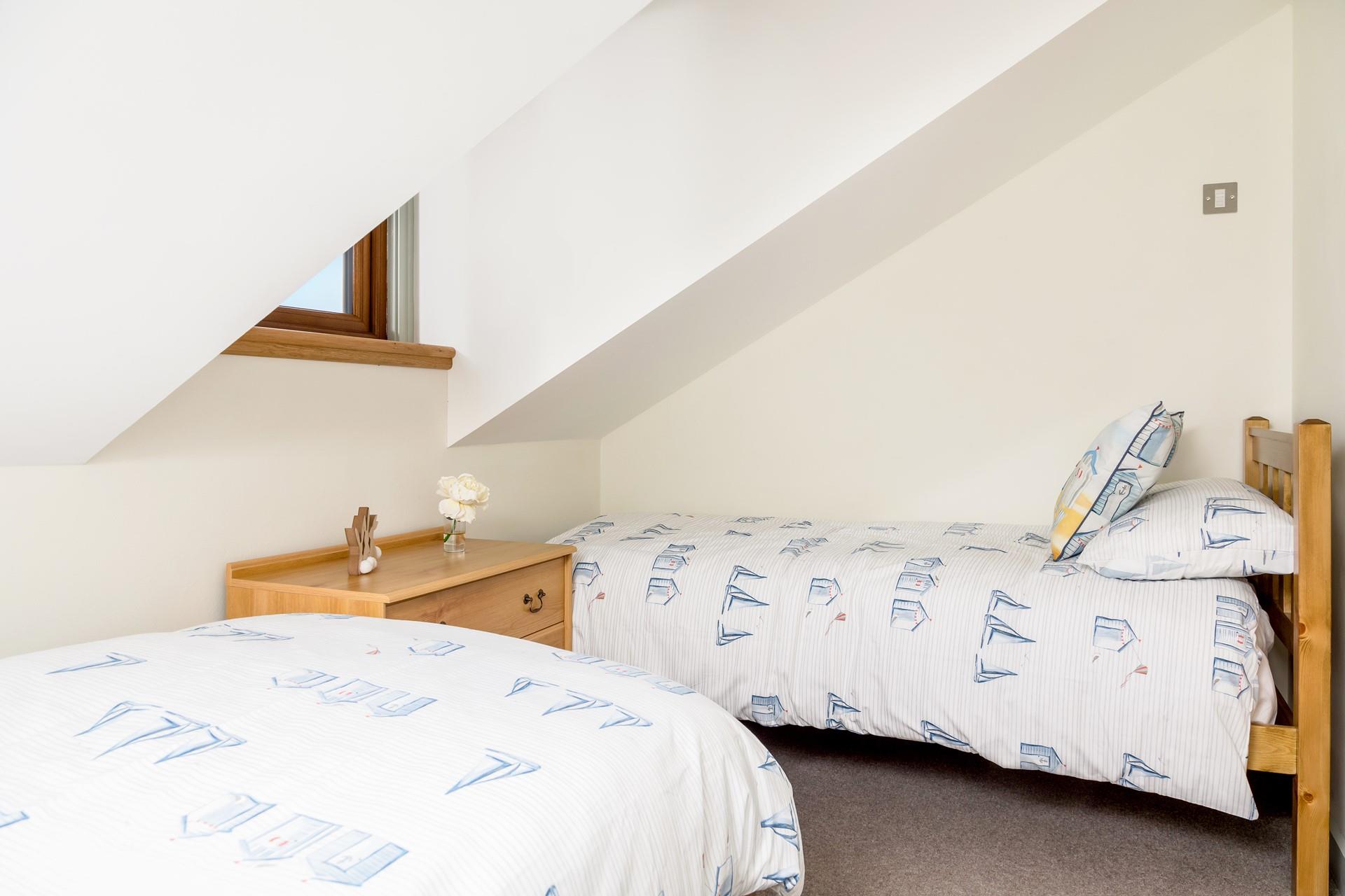 Bedroom 3 has seaside theme linen and is perfect for a relaxing night's sleep.