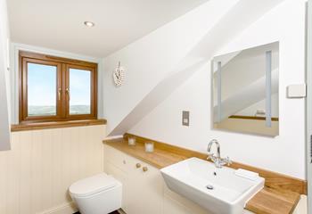 The family bathroom has an illuminated mirror for getting ready, the window overlooks the beautiful countryside.