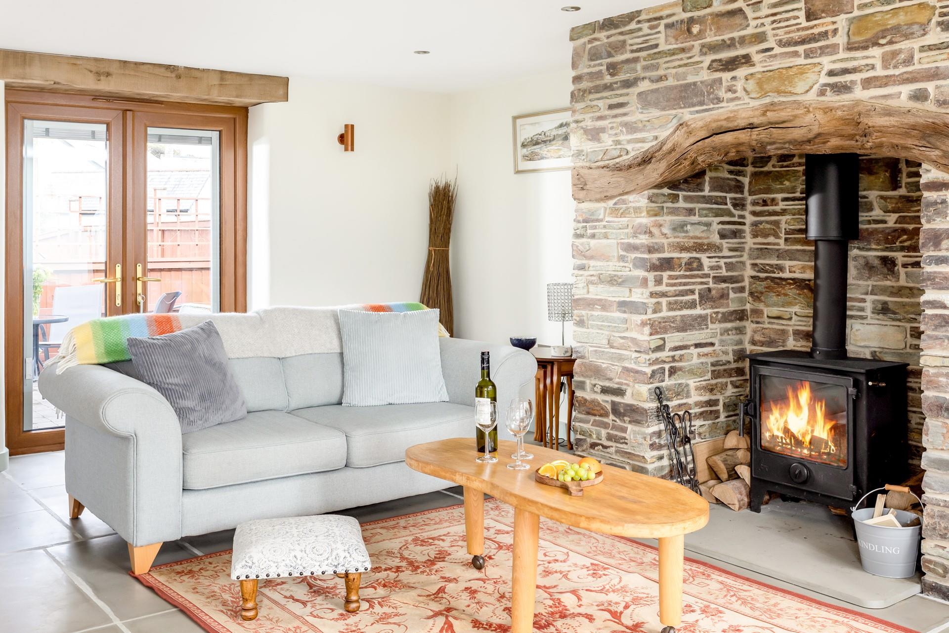 The sitting area is full of charm with the cottage-style inglenook fireplace, perfect for cosy evenings in.