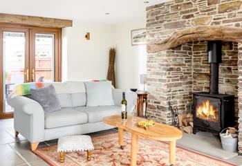 The sitting area is full of charm with the cottage-style inglenook fireplace, perfect for cosy evenings in.
