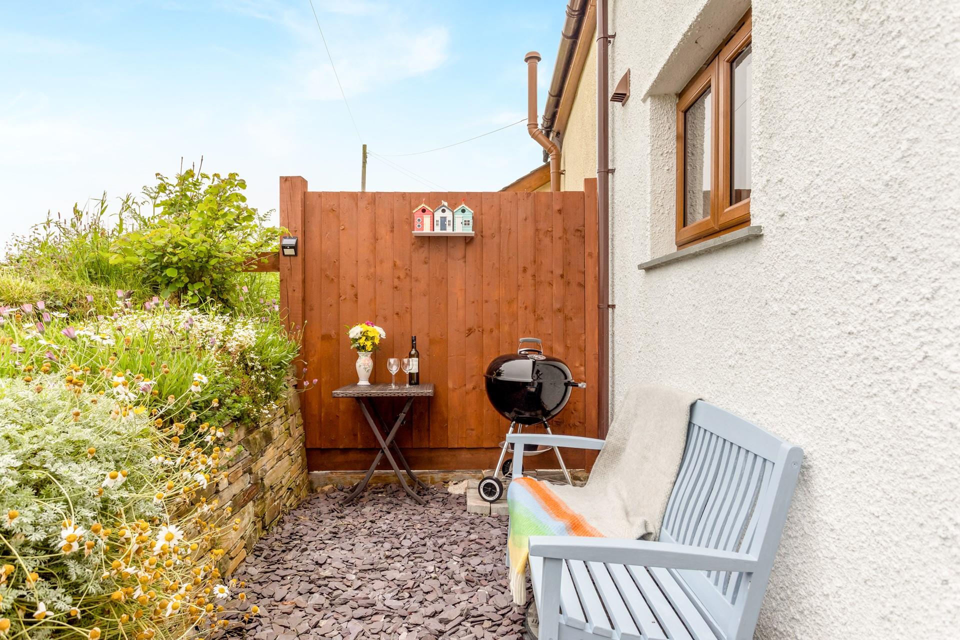 The rear gravelled area has a barbecue, perfect for alfresco dining.