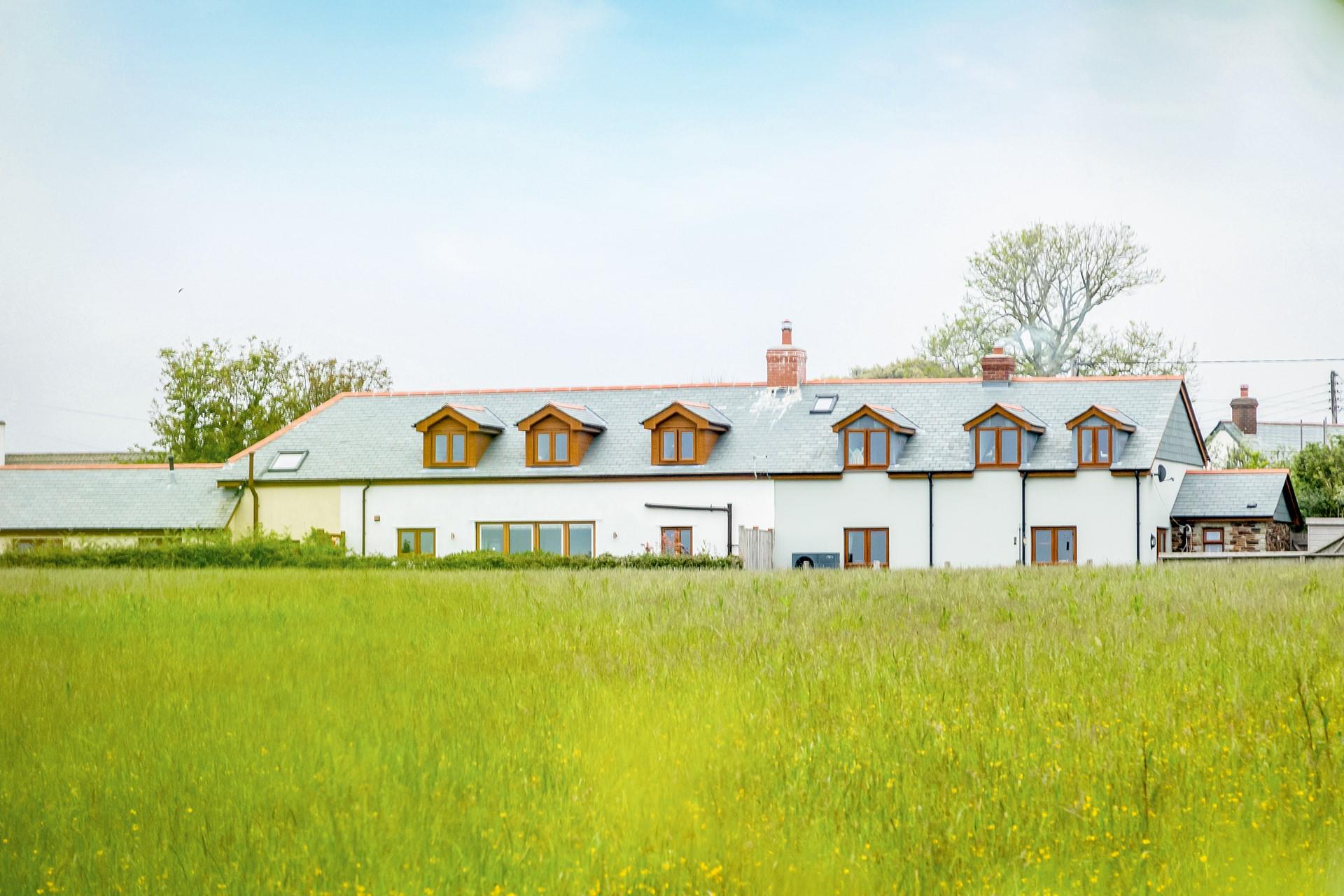 Overlooking meadows, relax in the living area, and watch the sunset over the Cornish countryside.